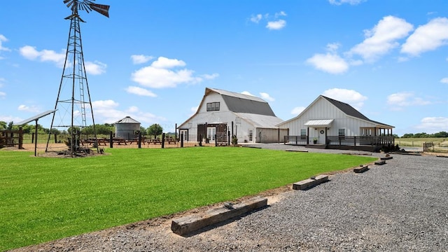 10506 W Smith Rd, El Reno, OK 73036 - back of property featuring a barn, board and batten siding, and an outbuilding