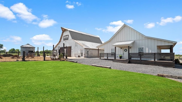 10506 W Smith Rd, El Reno, OK 73036 - back of house featuring board and batten siding, a barn, and an outdoor structure