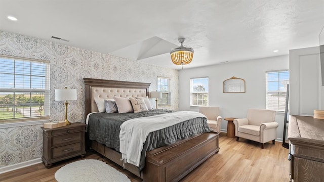 10506 W Smith Rd, El Reno, OK 73036 - bedroom featuring wallpapered walls, light wood-style flooring, recessed lighting, and a chandelier