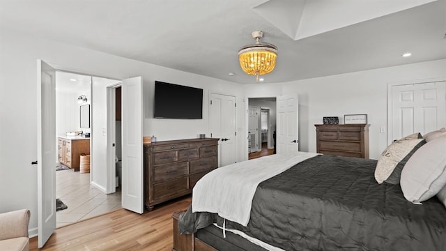 10506 W Smith Rd, El Reno, OK 73036 - bedroom with light wood finished floors, a chandelier, and recessed lighting