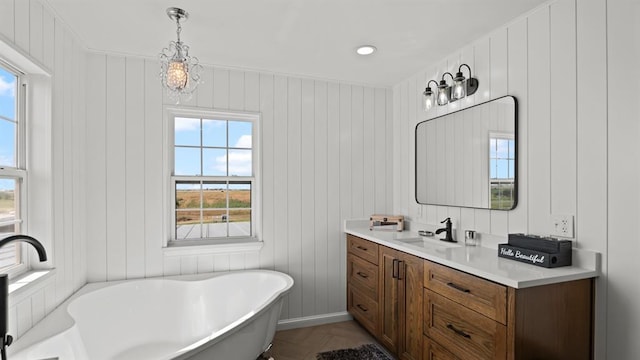 10506 W Smith Rd, El Reno, OK 73036 - bathroom with a freestanding tub, healthy amount of natural light, vanity, and a decorative wall