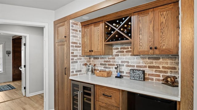 10506 W Smith Rd, El Reno, OK 73036 - indoor dry bar with wine cooler, refrigerator, light wood finished floors, and tasteful backsplash