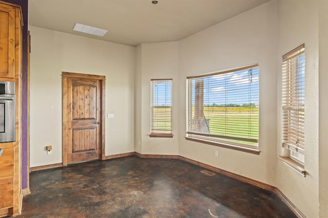 3895 NE Arrowhead Rd, Piedmont, OK 73078 - spare room with concrete flooring and baseboards