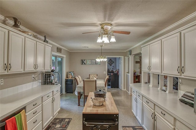 13086 240th, Blanchard, OK 73010 - kitchen featuring light countertops, a ceiling fan, ornamental molding, a chandelier, and decorative light fixtures