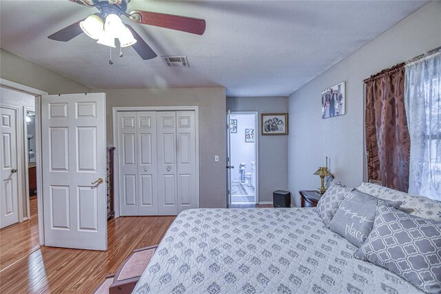 13086 240th, Blanchard, OK 73010 - bedroom with wood finished floors, a closet, and a ceiling fan