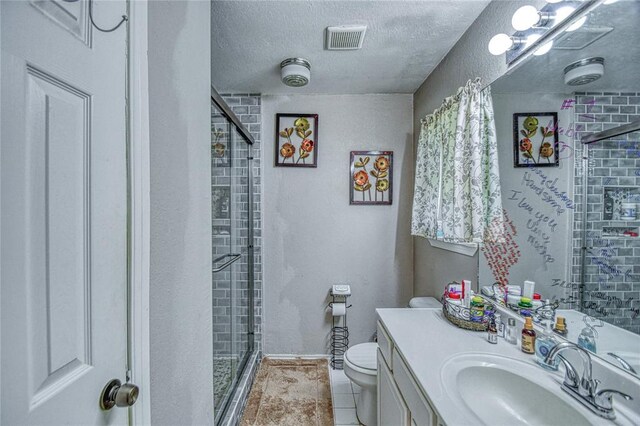 13086 240th, Blanchard, OK 73010 - bathroom featuring a shower stall, vanity, a textured ceiling, and tile patterned floors