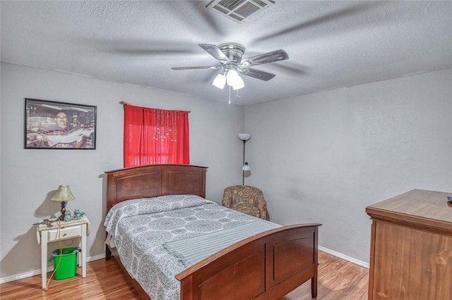 13086 240th, Blanchard, OK 73010 - bedroom with wood finished floors, a textured ceiling, and ceiling fan