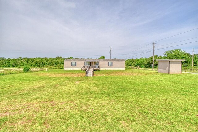 13086 240th, Blanchard, OK 73010 - view of green lawn featuring a storage unit