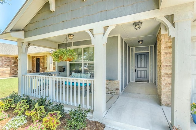 18217 Agua Dr, Edmond, OK 73012 - view of exterior entry featuring a porch