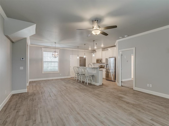 3713 Andrew Ct, Norman, OK 73072 - kitchen with stainless steel appliances, ornamental molding, a kitchen breakfast bar, light countertops, and baseboards