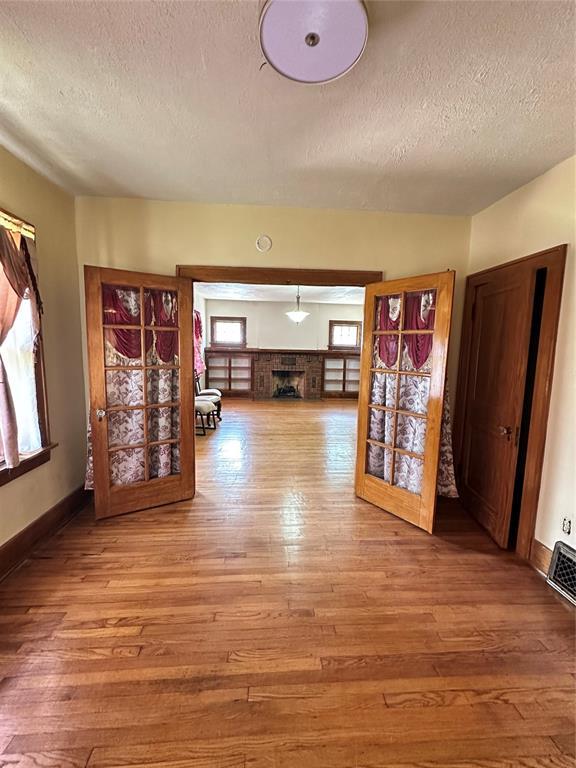 2001 NW 18th St, Oklahoma City, OK 73106 - corridor featuring a textured ceiling and hardwood / wood-style flooring