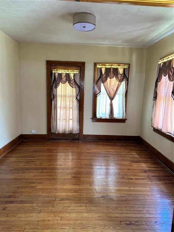 2001 NW 18th St, Oklahoma City, OK 73106 - spare room featuring a textured ceiling and hardwood / wood-style flooring