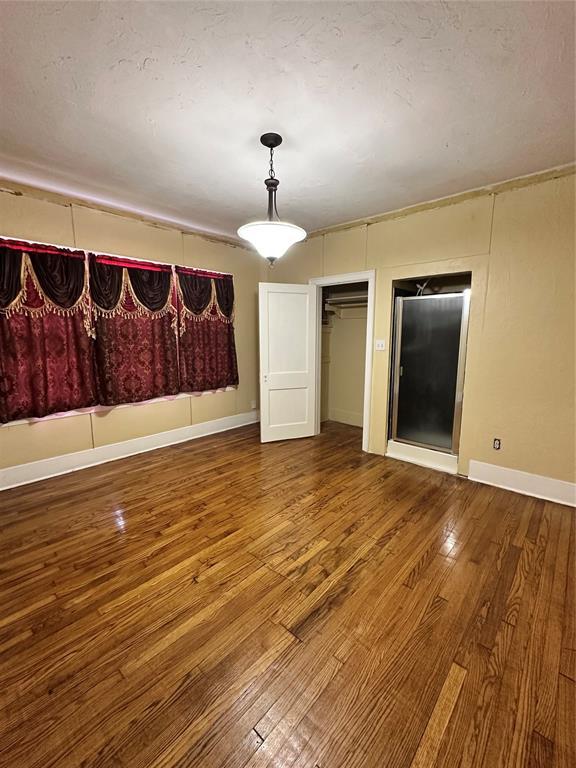2001 NW 18th St, Oklahoma City, OK 73106 - unfurnished dining area with wood-type flooring and baseboards