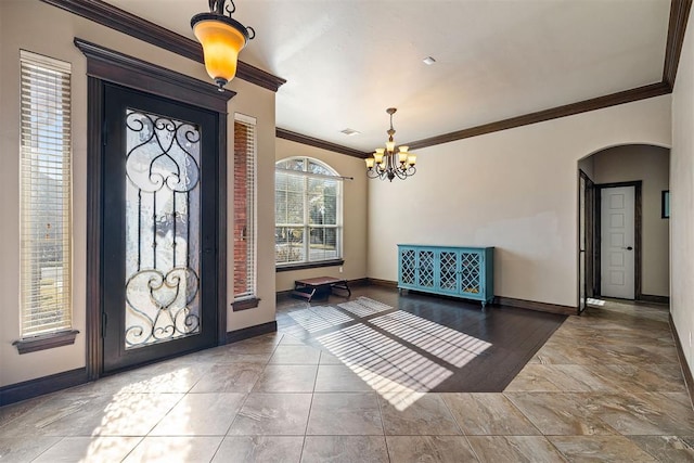 309 Turnberry Dr, Norman, OK 73069 - entrance foyer featuring crown molding, arched walkways, baseboards, and a chandelier