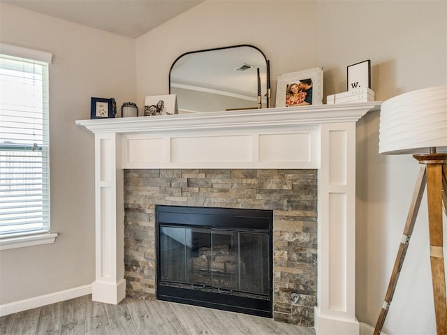 3911 Wiltshire Dr, Norman, OK 73026 - detailed view of wood finished floors, a stone fireplace, and baseboards