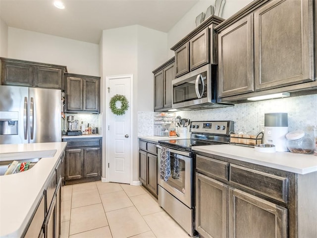 3911 Wiltshire Dr, Norman, OK 73026 - kitchen featuring appliances with stainless steel finishes, light countertops, backsplash, and recessed lighting