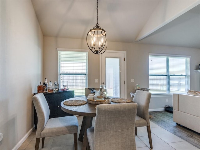 3911 Wiltshire Dr, Norman, OK 73026 - dining space with a chandelier, baseboards, vaulted ceiling, and light tile patterned floors