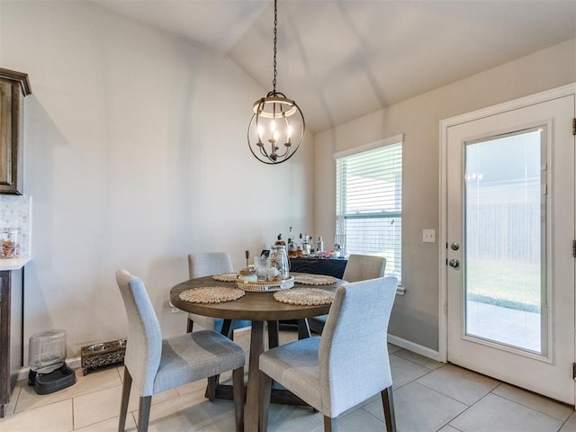 3911 Wiltshire Dr, Norman, OK 73026 - dining area featuring vaulted ceiling, light tile patterned floors, and a chandelier