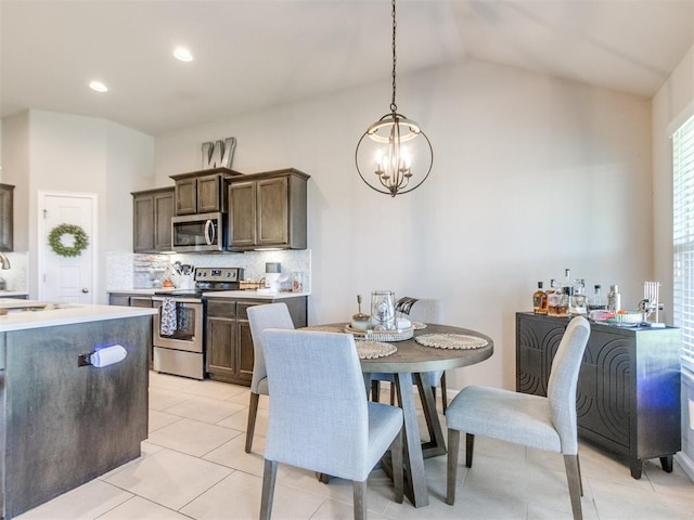 3911 Wiltshire Dr, Norman, OK 73026 - dining space featuring a chandelier, light tile patterned flooring, lofted ceiling, and recessed lighting