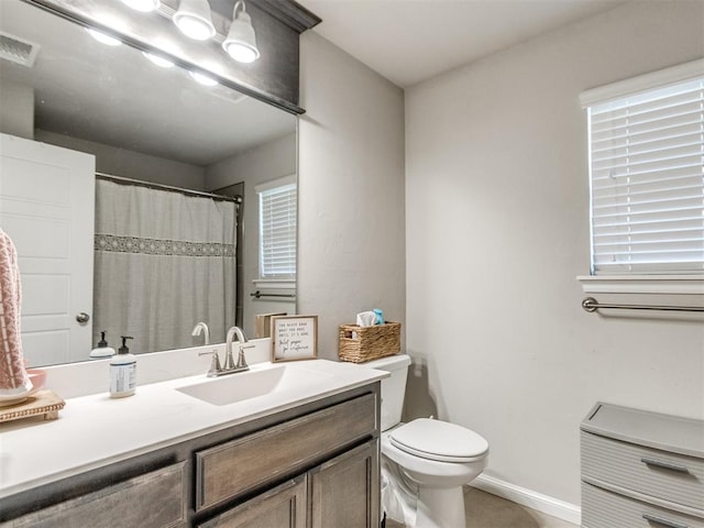 3911 Wiltshire Dr, Norman, OK 73026 - bathroom featuring toilet, vanity, baseboards, and curtained shower