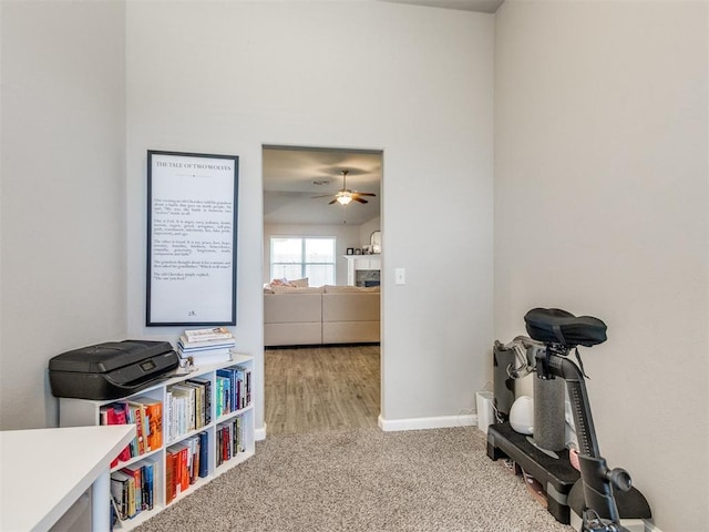 3911 Wiltshire Dr, Norman, OK 73026 - workout room featuring a ceiling fan, a fireplace, baseboards, and carpet flooring