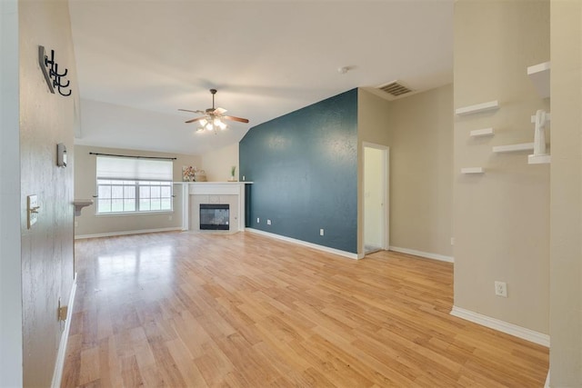 5600 Darla Dr, Oklahoma City, OK 73135 - unfurnished living room with ceiling fan, light wood-style floors, a tiled fireplace, and lofted ceiling
