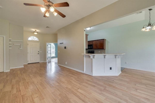 5600 Darla Dr, Oklahoma City, OK 73135 - unfurnished living room with light wood finished floors, a ceiling fan, and a chandelier