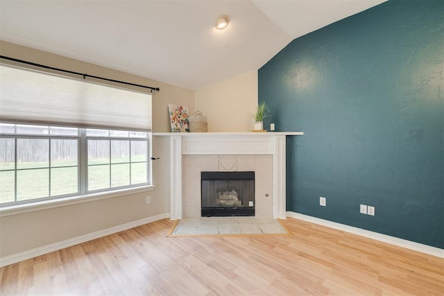5600 Darla Dr, Oklahoma City, OK 73135 - unfurnished living room featuring wood finished floors, lofted ceiling, and a fireplace