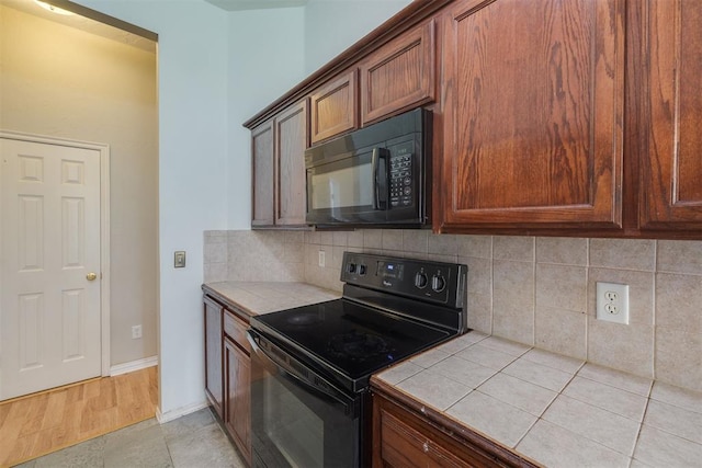 5600 Darla Dr, Oklahoma City, OK 73135 - kitchen featuring black appliances, tile counters, and tasteful backsplash