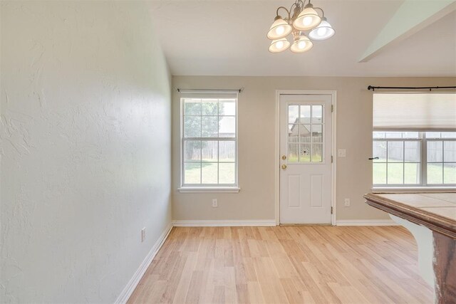 5600 Darla Dr, Oklahoma City, OK 73135 - entrance foyer featuring a chandelier, light wood finished floors, and vaulted ceiling