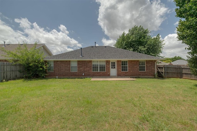 5600 Darla Dr, Oklahoma City, OK 73135 - back of property featuring a patio, brick siding, a fenced backyard, and a shingled roof