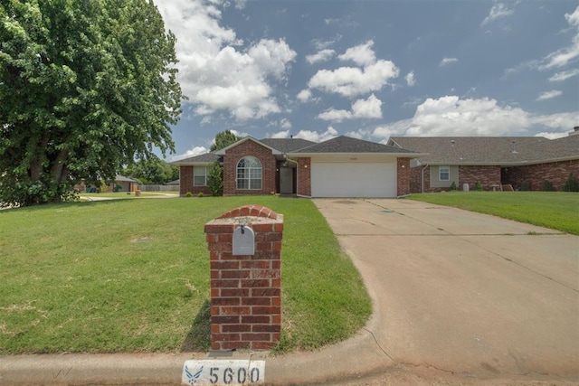 5600 Darla Dr, Oklahoma City, OK 73135 - ranch-style house featuring brick siding, an attached garage, driveway, and a front lawn