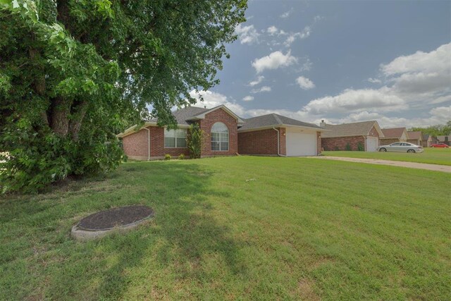 5600 Darla Dr, Oklahoma City, OK 73135 - ranch-style house with a garage, concrete driveway, a front yard, and brick siding