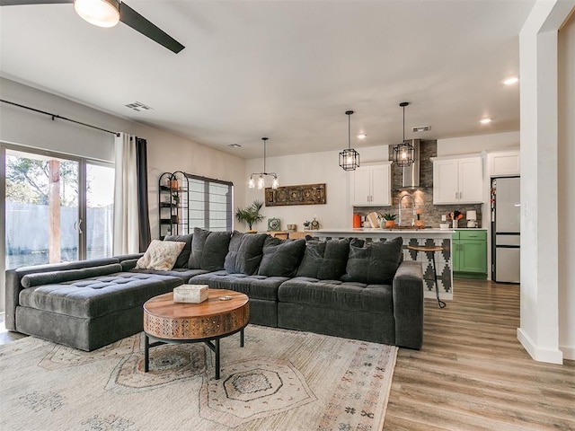 8324 NW 151st Ter, Edmond, OK 73013 - living room featuring light wood-type flooring, a chandelier, recessed lighting, and ceiling fan