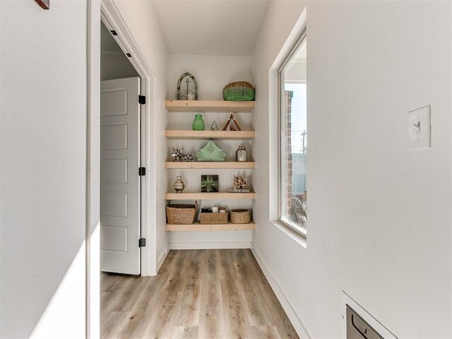 8324 NW 151st Ter, Edmond, OK 73013 - corridor with light wood-style flooring and healthy amount of natural light