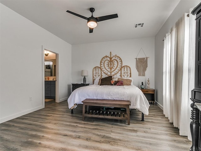 8324 NW 151st Ter, Edmond, OK 73013 - bedroom with light wood-style flooring, ensuite bathroom, baseboards, and ceiling fan