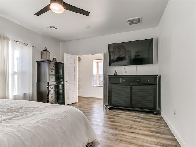 8324 NW 151st Ter, Edmond, OK 73013 - bedroom featuring wood finished floors, baseboards, and ceiling fan