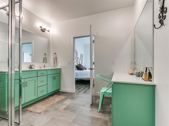 8324 NW 151st Ter, Edmond, OK 73013 - full bath with double vanity and baseboards