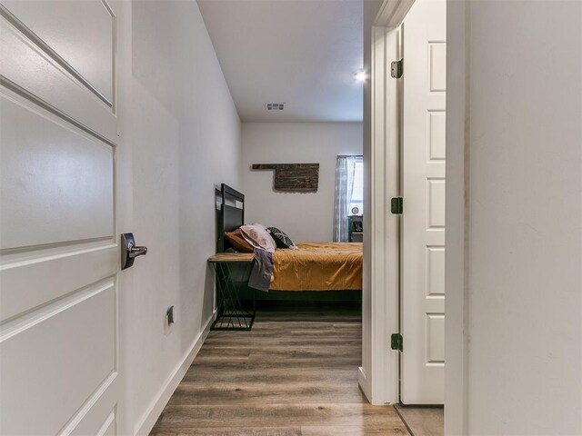 8324 NW 151st Ter, Edmond, OK 73013 - bedroom with wood finished floors and baseboards