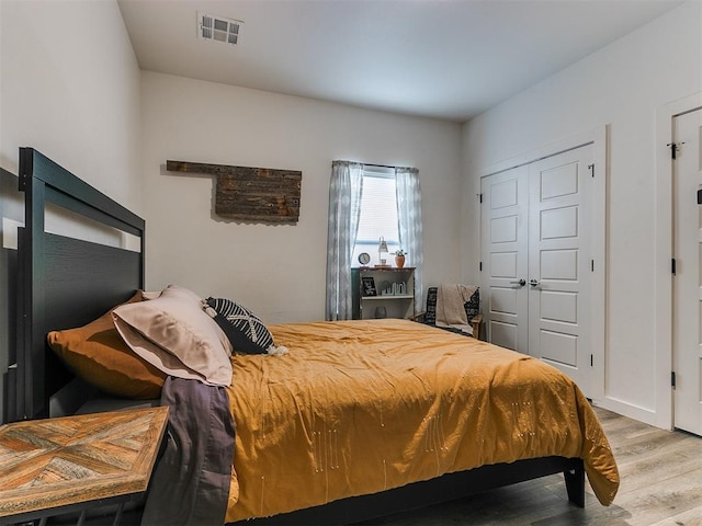 8324 NW 151st Ter, Edmond, OK 73013 - bedroom featuring wood finished floors and a closet