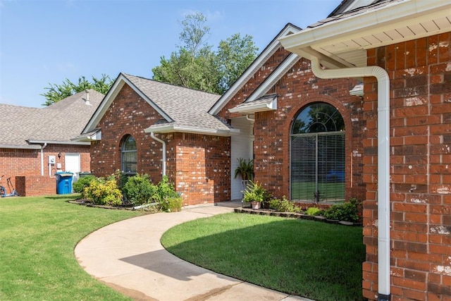 12432 Hastings Rd, Midwest City, OK 73130 - view of front of house with brick siding, a front lawn, and roof with shingles