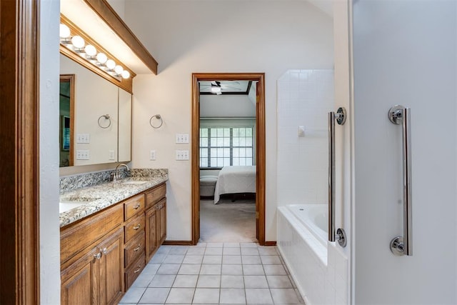 12432 Hastings Rd, Midwest City, OK 73130 - ensuite bathroom featuring double vanity, vaulted ceiling, tile patterned flooring, a ceiling fan, and tub / shower combination