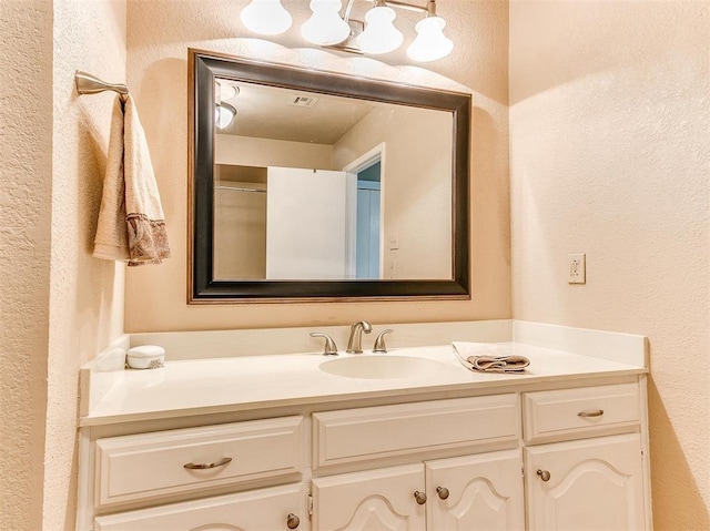 7817 Old Hickory Ln, Oklahoma City, OK 73116 - bathroom with a textured wall and vanity