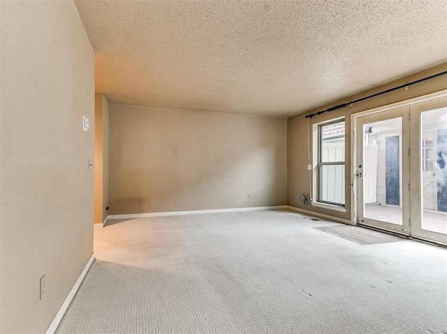 7817 Old Hickory Ln, Oklahoma City, OK 73116 - carpeted spare room featuring baseboards and a textured ceiling