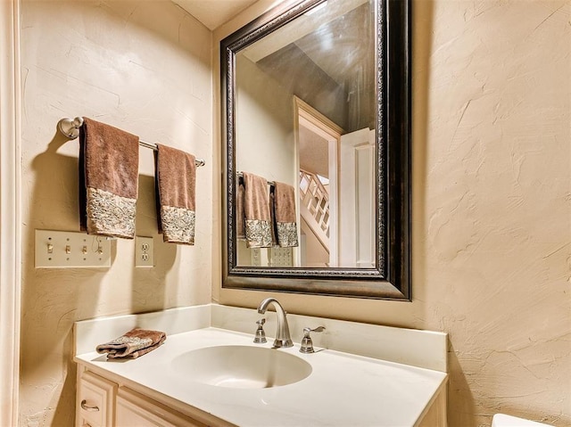 7817 Old Hickory Ln, Oklahoma City, OK 73116 - half bath with vanity and a textured wall
