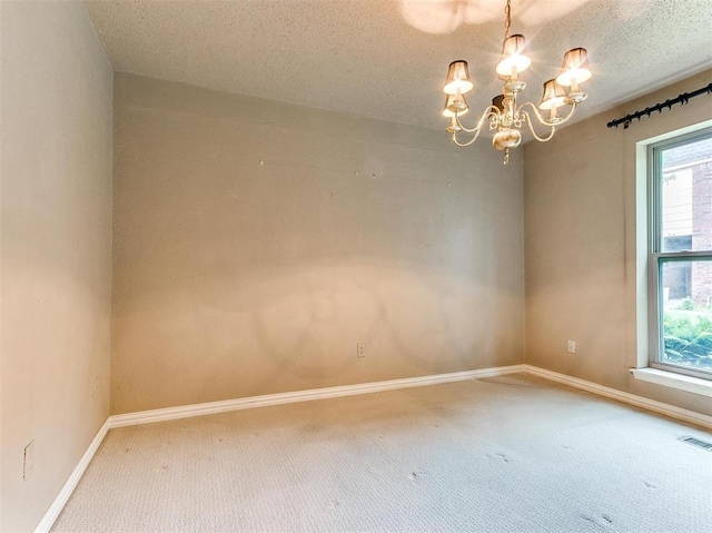 7817 Old Hickory Ln, Oklahoma City, OK 73116 - unfurnished room with carpet flooring, a chandelier, and a textured ceiling