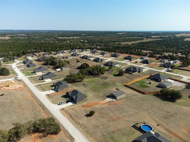 2515 Gallant Fox Ter, Guthrie, OK 73044 - aerial view of property and surrounding area featuring a heavily wooded area and nearby suburban area
