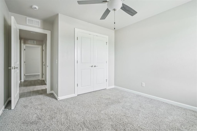 1513 Reid Pryor Rd, Norman, OK 73072 - unfurnished bedroom with carpet flooring, a closet, and a ceiling fan