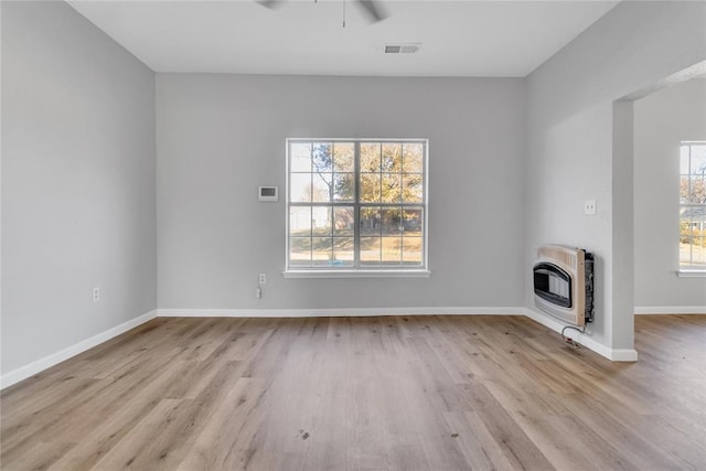 501 SW 2nd St, Tuttle, OK 73089 - unfurnished living room with heating unit, a ceiling fan, wood finished floors, and baseboards