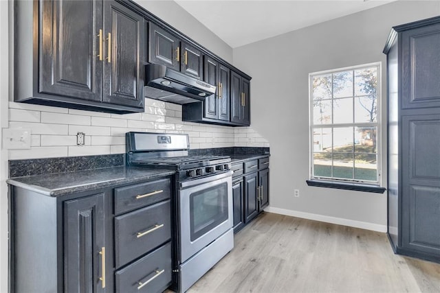 501 SW 2nd St, Tuttle, OK 73089 - kitchen featuring gas range, under cabinet range hood, dark countertops, and healthy amount of natural light